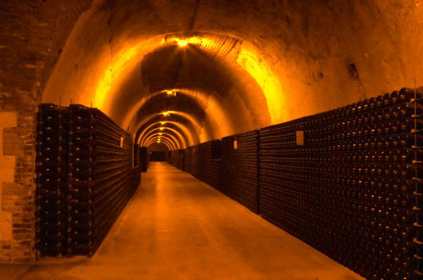 An underground wine cellar in Champagne with thousands of wine bottles