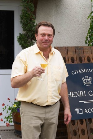 Claude Giraud, owner and winemaker, tasting a glass of his champagne