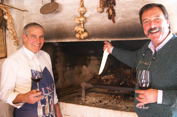 Daniel Pisano and the barbecue cook supervising the meat on the grill