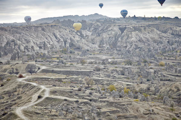 Balloons over the landscape in Cappadocia, Pigeon Valley, Turkey