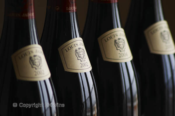 A row of bottles of burgundy wine from Maison Louis Jadot