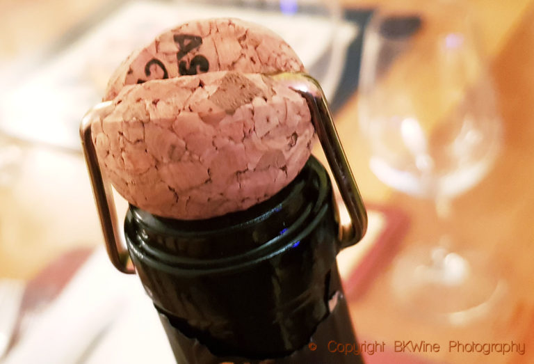 An old-fashioned clamp keeping the cork in place on a sparkling wine