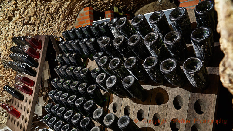 Bottles in pupitres in the cellars of Champagne Paul Dethune