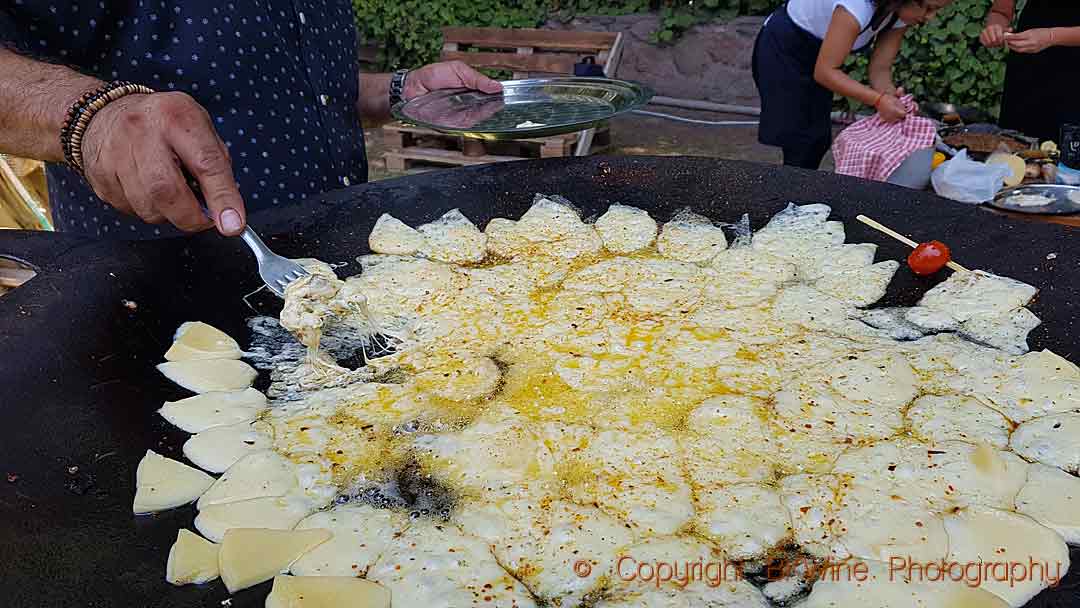 Frying cheese for an asado at Bodegas Weinert, Mendoza, Argentina