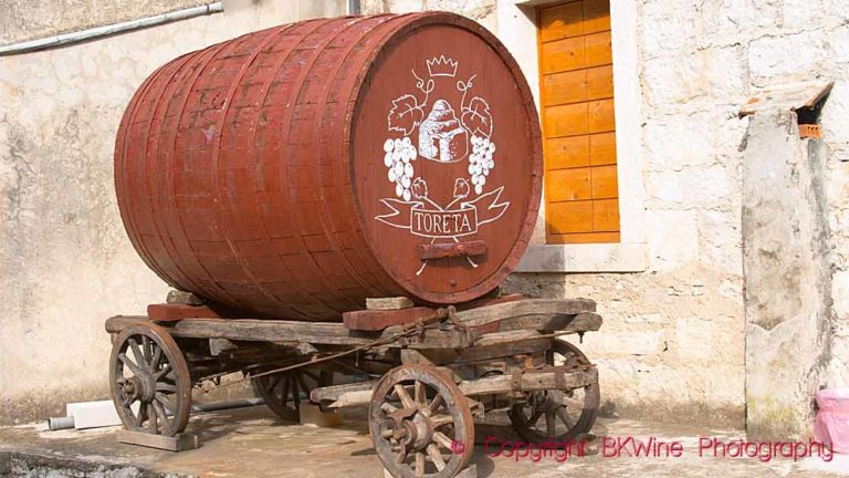 An old cart with a barrel to transport wine at the Toreta winery on Korcula Island in Croatia