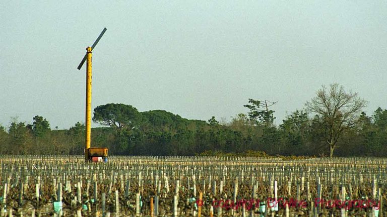 An anti-frost wind machine, propeller tower, of an old style, in a vineyard in Bordeaux