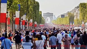 Big crowds on the Champs-Elysees in Paris with the Arc de Triomphe